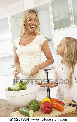 Picture - Mother & Daughter Preparing Salad In Modern Kitchen. Fotosearch