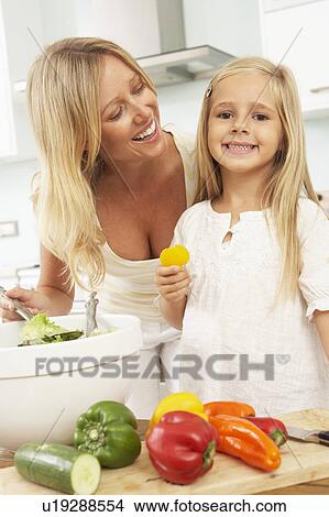 Mother & Daughter Preparing Salad In Modern Kitchen View Large Photo Image Picture - Mother & Daughter Preparing Salad In Modern Kitchen. Fotosearch