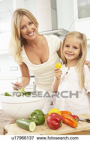 Stock Photo - Mother & Daughter Preparing Salad In Modern Kitchen. Fotosearch