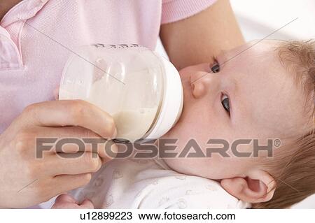Mother Giving Bottle Baby Boy At Home View Large Photo Image Stock Image - Mother Giving Bottle Baby Boy At Home. Fotosearch