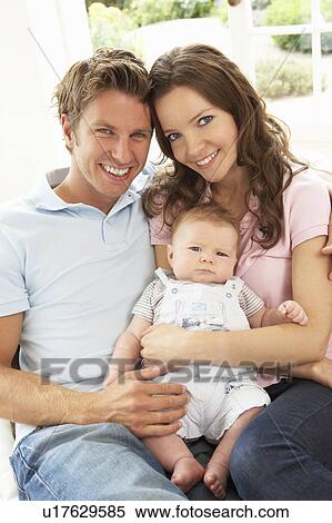 Parents Cuddling Newborn Baby Boy At Home View Large Photo Image Stock Photography - Parents Cuddling Newborn Baby Boy At Home. Fotosearch