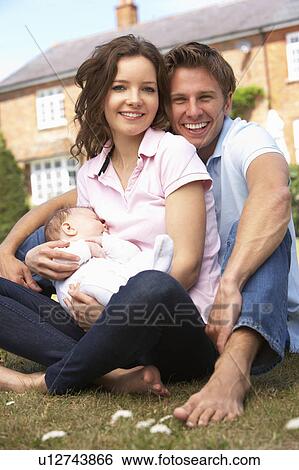 Parents Cuddling Newborn Baby Boy Outdoors At Home View Large Photo Image Stock Photograph - Parents Cuddling Newborn Baby Boy Outdoors At Home. Fotosearch
