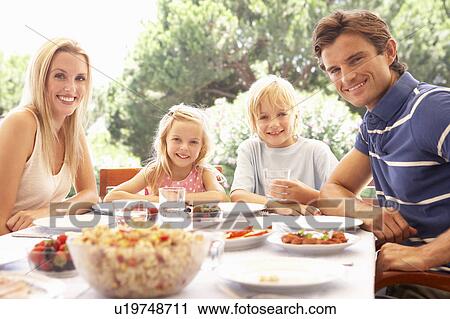 Parents, with children, enjoy a picnic View Large Photo Image Stock Image - Parents, with children, enjoy a picnic. Fotosearch