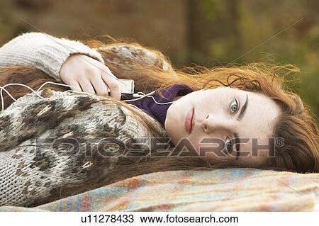 Portrait Of Beautiful Teenage Girl Outdoors Listening To MP3 Player In Autumn Landscape View Large Photo Image Stock Image - Portrait Of Beautiful Teenage Girl Outdoors Listening To MP3 Player In Autumn Landscape. Fotosearch