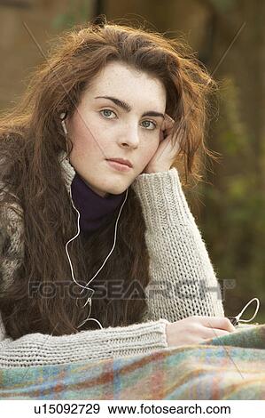 Portrait Of Beautiful Teenage Girl Outdoors Listening To MP3 Player In Autumn Landscape View Large Photo Image Stock Photo - Portrait Of Beautiful Teenage Girl Outdoors Listening To MP3 Player In Autumn Landscape. Fotosearch