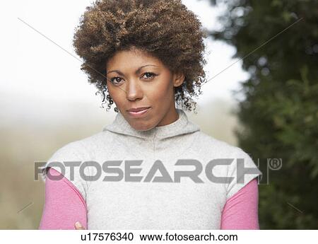 Stock Image - Portrait Of Beautiful Woman In Garden. Fotosearch