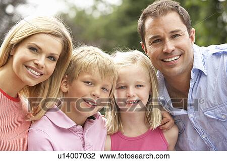 Stock Image - Portrait Of Family Relaxing In Countryside. Fotosearch