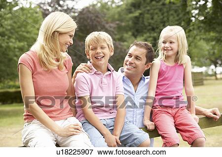Portrait Of Family Sitting On Fence In Countryside View Large Photo Image Stock Photo - Portrait Of Family Sitting On Fence In Countryside. Fotosearch