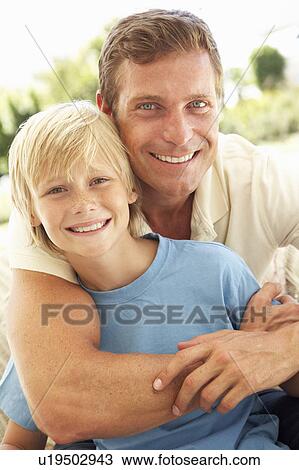 Portrait Of Father And Son Relaxing On Sofa View Large Photo Image Stock Image - Portrait Of Father And Son Relaxing On Sofa. Fotosearch