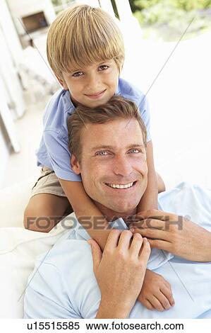 Portrait Of Father And Son Relaxing On Sofa View Large Photo Image Stock Photography - Portrait Of Father And Son Relaxing On Sofa. Fotosearch
