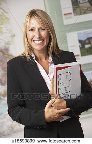 Portrait Of Female Estate Agent In Office View Large Photo Image Stock Photo - Portrait Of Female Estate Agent In Office. Fotosearch