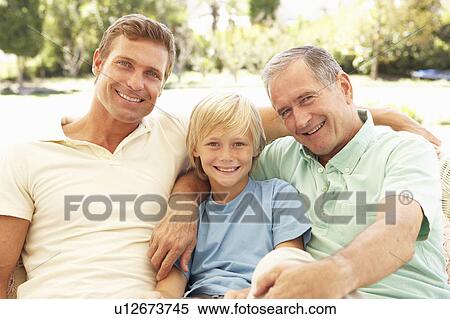 Stock Photography - Portrait Of Grandfather, Son And Grandson Relaxing On Sofa. Fotosearch