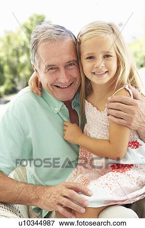 Portrait Of Grandfather With Granddaughter Relaxing Together On Sofa View Large Photo Image Stock Photo - Portrait Of Grandfather With Granddaughter Relaxing Together On Sofa. Fotosearch