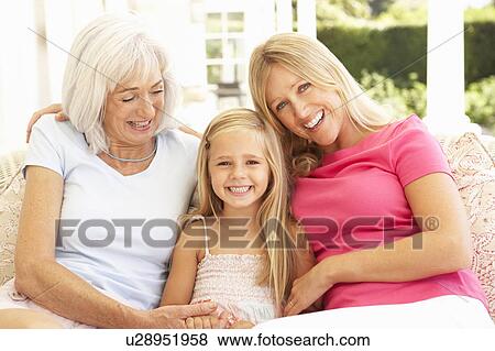 Portrait Of Grandmother, Daughter And Granddaughter Relaxing On Sofa View Large Photo Image Stock Photo - Portrait Of Grandmother, Daughter And Granddaughter Relaxing On Sofa. Fotosearch