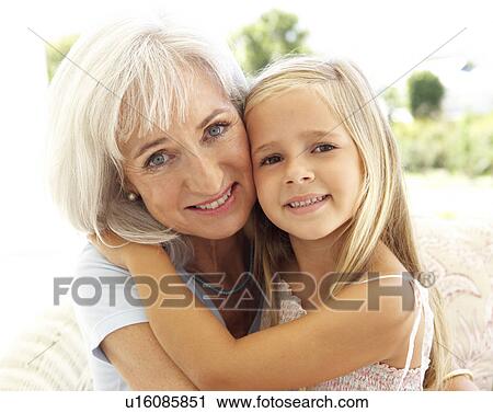Portrait Of Grandmother With Granddaughter Relaxing Together On Sofa View Large Photo Image Stock Image - Portrait Of Grandmother With Granddaughter Relaxing Together On Sofa. Fotosearch