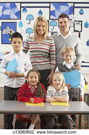 Portrait Of Group Of Primary Schoolchildren And Teachers Sitting At Desk In Classroom View Large Photo Image Stock Image - Portrait Of Group Of Primary Schoolchildren And Teachers Sitting At Desk In Classroom. Fotosearch