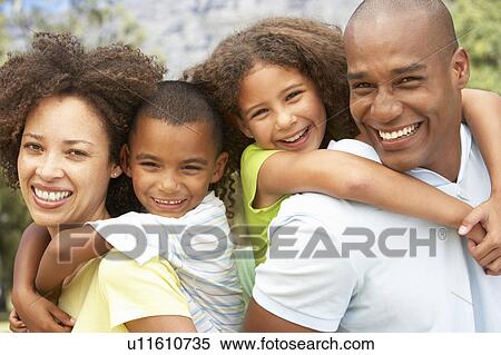 Stock Photography - Portrait of Happy Family In Park. Fotosearch