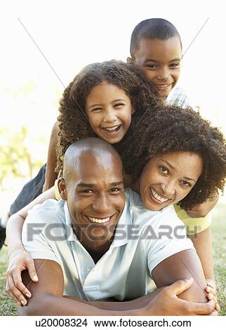 Portrait of Happy Family Piled Up In Park View Large Photo Image Picture - Portrait of Happy Family Piled Up In Park. Fotosearch