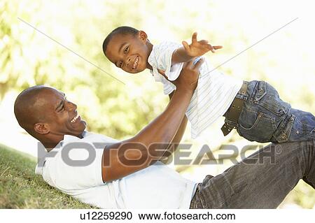 Portrait of Happy Father and Son In Park View Large Photo Image Stock Image - Portrait of Happy Father and Son In Park. Fotosearch