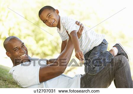 Stock Image - Portrait of Happy Father and Son In Park. Fotosearch