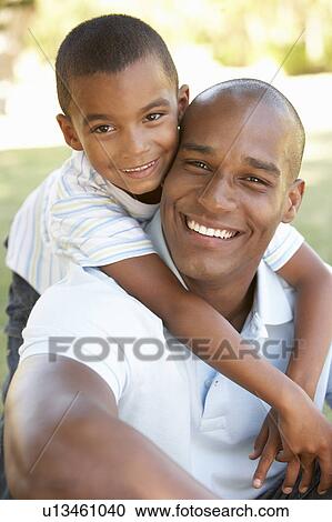 Portrait of Happy Father and Son In Park View Large Photo Image Stock Image - Portrait of Happy Father and Son In Park. Fotosearch