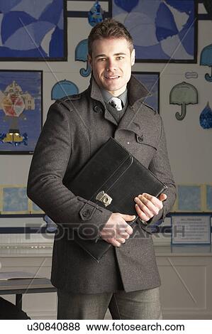 Portrait Of Male Primary School Teacher Standing In Classroom View Large Photo Image Stock Photo - Portrait Of Male Primary School Teacher Standing In Classroom. Fotosearch