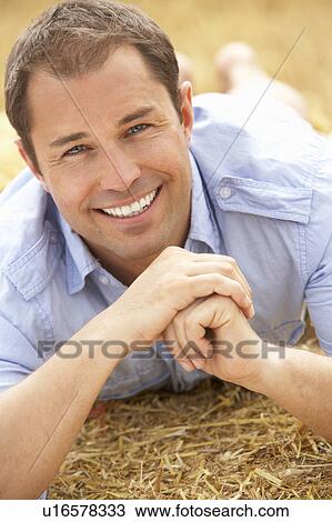 Portrait Of Man Laying In Summer Harvested Field View Large Photo Image Stock Image - Portrait Of Man Laying In Summer Harvested Field. Fotosearch