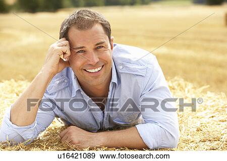 Portrait Of Man Laying In Summer Harvested Field View Large Photo Image Stock Photo - Portrait Of Man Laying In Summer Harvested Field. Fotosearch
