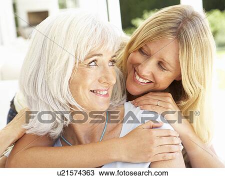 Portrait Of Mother And Adult Daughter Relaxing On Sofa View Large Photo Image Stock Image - Portrait Of Mother And Adult Daughter Relaxing On Sofa. Fotosearch