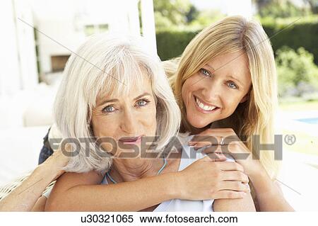 Portrait Of Mother And Adult Daughter Relaxing On Sofa View Large Photo Image Stock Photography - Portrait Of Mother And Adult Daughter Relaxing On Sofa. Fotosearch