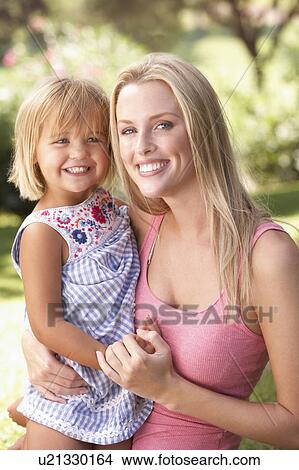 Picture - Portrait Of Mother And Child Relaxing In Park. Fotosearch