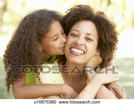 Stock Image - Portrait Of Mother And Daughter In Park. Fotosearch