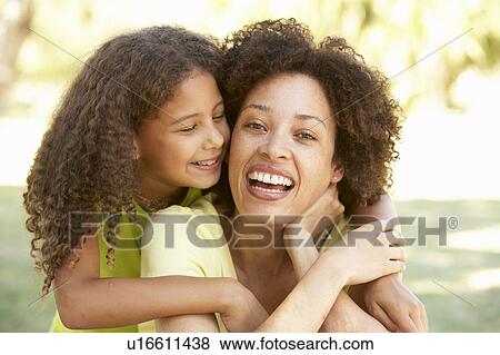 Stock Photo - Portrait Of Mother And Daughter In Park. Fotosearch