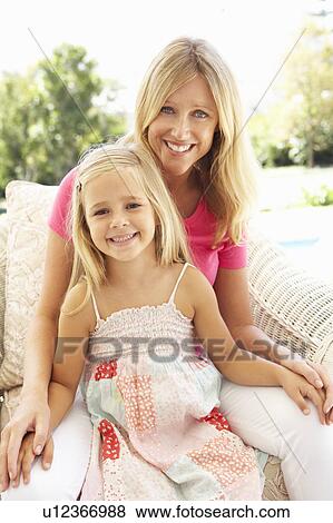 Portrait Of Mother And Daughter Relaxing On Sofa View Large Photo Image Stock Photo - Portrait Of Mother And Daughter Relaxing On Sofa. Fotosearch