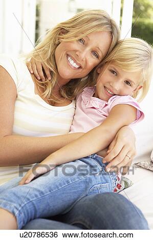 Portrait Of Mother And Daughter Relaxing On Sofa View Large Photo Image Stock Photograph - Portrait Of Mother And Daughter Relaxing On Sofa. Fotosearch