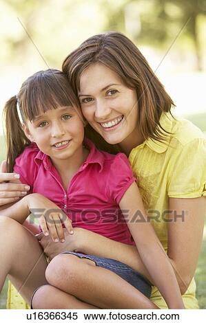 Stock Photography - Portrait Of Mother And Daughter Together In Park. Fotosearch