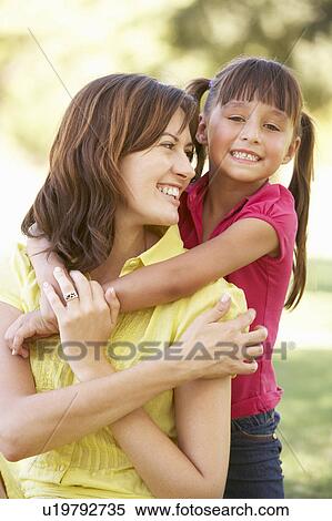 Stock Photography - Portrait Of Mother And Daughter Together In Park. Fotosearch