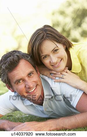 Stock Image - Portrait Of Romantic Couple In Park. Fotosearch