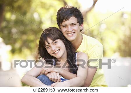 Portrait Of Romantic Teenage Couple Sitting In Park View Large Photo Image Stock Image - Portrait Of Romantic Teenage Couple Sitting In Park. Fotosearch