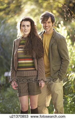 Stock Image - Portrait Of Romantic Young Couple In Autumn Landscape. Fotosearch