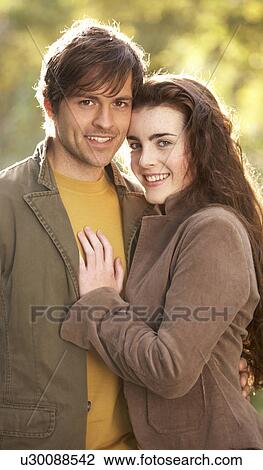 Stock Image - Portrait Of Romantic Young Couple In Autumn Landscape. Fotosearch