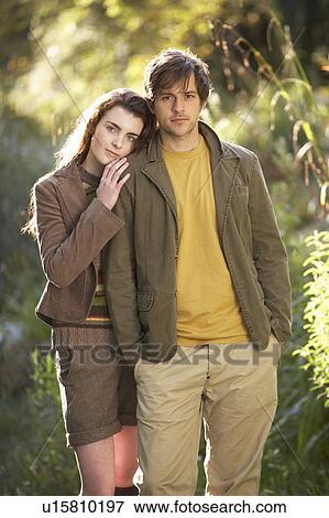 Stock Photo - Portrait Of Romantic Young Couple In Autumn Landscape. Fotosearch