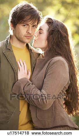 Stock Photo - Portrait Of Romantic Young Couple In Autumn Landscape. Fotosearch