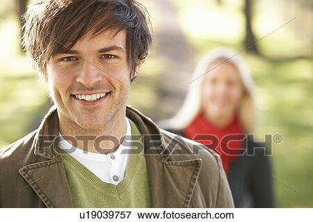 Portrait Of Romantic Young Couple In Autumn Park View Large Photo Image Stock Photo - Portrait Of Romantic Young Couple In Autumn Park. Fotosearch