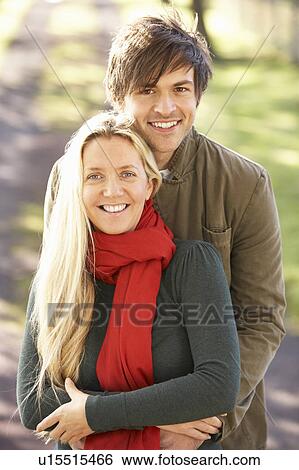 Stock Photograph - Portrait Of Romantic Young Couple In Autumn Park. Fotosearch