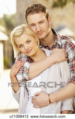 Stock Image - Portrait Of Romantic Young Couple Embracing. Fotosearch