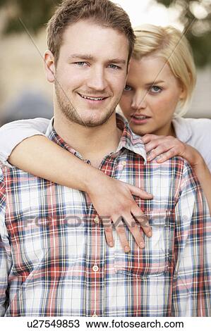 Stock Image - Portrait Of Romantic Young Couple Embracing. Fotosearch