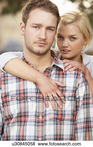 Stock Photo - Portrait Of Romantic Young Couple Embracing. Fotosearch