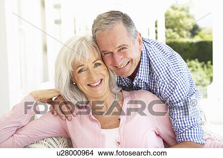 Portrait Of Senior Couple Relaxing Together On Sofa View Large Photo Image Picture - Portrait Of Senior Couple Relaxing Together On Sofa. Fotosearch