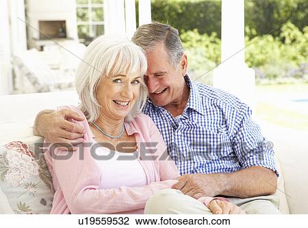 Portrait Of Senior Couple Relaxing Together On Sofa View Large Photo Image Stock Image - Portrait Of Senior Couple Relaxing Together On Sofa. Fotosearch